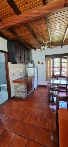 a kitchen with a table and a stove at Casa de Piedra in Termas del Daymán