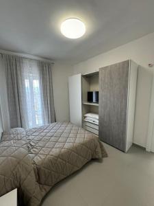 a bedroom with a bed and a large window at CASA LUISA - Comfortable APT in San Vitaliano 