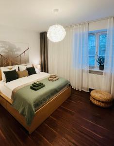 a bedroom with a large bed and a chandelier at Apartment M4 in Salzburg