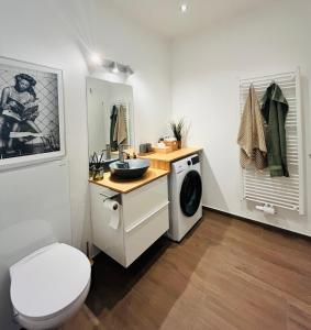 a bathroom with a sink and a washing machine at Apartment M4 in Salzburg