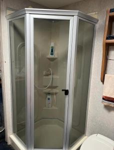 a glass shower in a bathroom with a toilet at Retreat (rinconcito) in Hildale