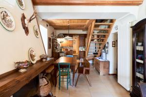 a kitchen and dining room with a wooden table and chairs at Conte Moro, ospitalità in Vanoi in Canale San Bovo