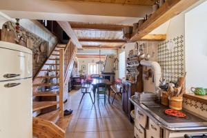 a kitchen with a stairs leading to a dining room at Conte Moro, ospitalità in Vanoi in Canale San Bovo