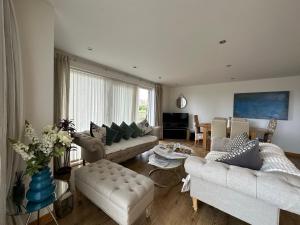 a living room with two couches and a table at Luxury 3 Specious Bedrooms Apartment in Edinburgh in Edinburgh