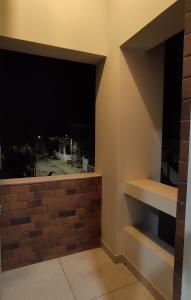 a room with a window with a brick wall at ''Go Desert'' Homestay in Bhuj