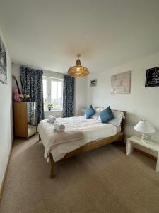 a bedroom with a large bed with blue pillows at Luxury 3 Specious Bedrooms Apartment in Edinburgh in Edinburgh