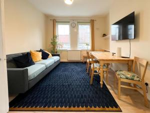 a living room with a couch and a table at West End Gem 3BR Detached Family House in Glasgow