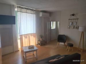 a living room with a couch and a table at Gites Terre et Ciel in Largentière