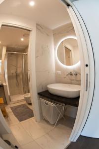 a bathroom with a sink and a mirror at Bubi House Porta Romana in Milan