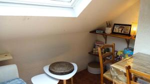 a room with a table and chairs and a window at Résidence Le Palos - A deux pas du téléphérique Résidence PALOS appartement 6 personnes MAE-0754 in Cadeilhan-Trachère