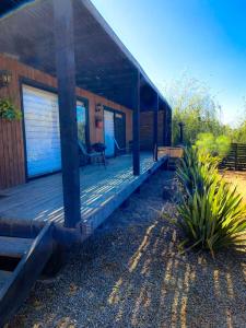 a wooden porch of a house with a patio at Cabaña con Tinaja -Litueche in Navidad