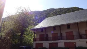 ein Haus mit einem Balkon und einem Berg im Hintergrund in der Unterkunft Résidence Eugenie - 2 Pièces pour 4 Personnes 964 in Guchen