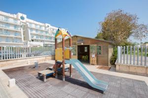 a playground with a slide next to a building at Mar Hotels Playa de Muro Suites in Playa de Muro