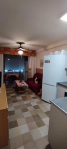 a kitchen and living room with a white refrigerator at Urbanización la barca in Oropesa del Mar