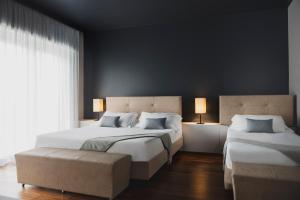 a bedroom with two beds and a large window at The Regent Boutique Hotel & Spa PRE OPENING in San Marino +33 photos