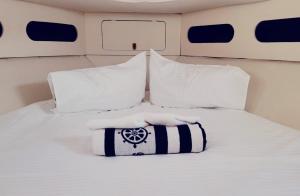 a bed with white pillows and snow on it at Cosy and Homey Houseboat Castelldefels in Barcelona