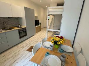 a kitchen with a table with plates and flowers on it at Casa Bruno in Marciana
