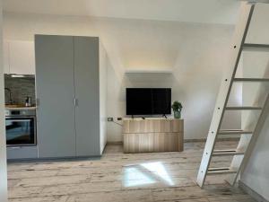 a living room with a television and a staircase at Casa Bruno in Marciana +12 photos