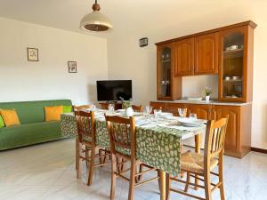 a dining room with a table and chairs and a couch at Tuscany Panoramic View - Relax in Val D'Orcia in Seggiano