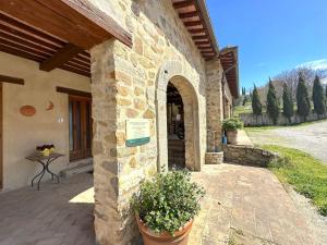 an entrance to a stone building with a patio at Tuscany Panoramic View - Relax in Val D'Orcia in Seggiano