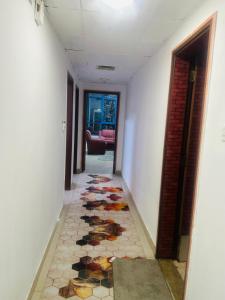 a hallway with a mosaic floor in a house at Tranquil Haven King Bed Ensuite Fully Furnished Bedroom in Ajman 