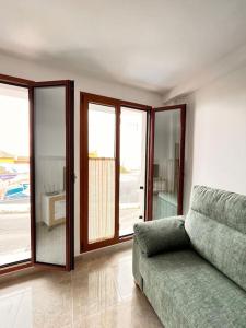a living room with a couch and sliding glass doors at Descanso y Encanto en Vilaflor in Vilaflor