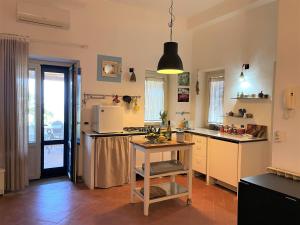 a kitchen with a island in the middle of a room at Le Case di Eolo in Malfa