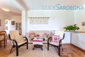 A seating area at Alghero Villa Barranch with sea view swimming pool for 6 people