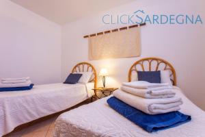A bed or beds in a room at Alghero Villa Barranch with sea view swimming pool for 6 people
