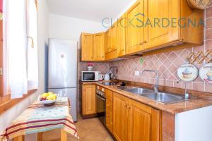 A kitchen or kitchenette at Alghero Villa Barranch with sea view swimming pool for 6 people
