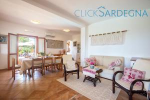 A seating area at Alghero Villa Barranch with sea view swimming pool for 6 people
