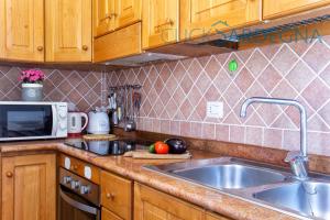 A kitchen or kitchenette at Alghero Villa Barranch with sea view swimming pool for 6 people