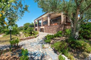 A garden outside Alghero Villa Barranch with sea view swimming pool for 6 people