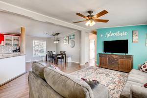 a living room with a couch and a flat screen tv at La Verkin Home with Yard, Covered Patio and Grill in La Verkin