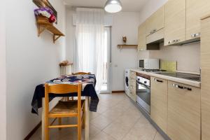 a kitchen with a table and a counter top at Residence Uno Studio&Suites in Rimini