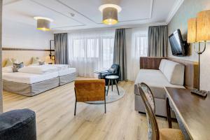 a hotel room with a bed and a couch at Hotel Brigitte in Ischgl +37 photos
