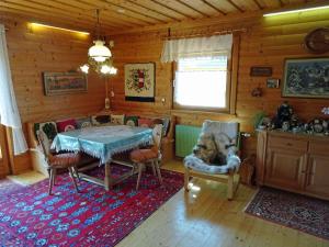 a room with a table and chairs in a cabin at Chalet in Diex near Klopeiner See with sauna in Diex