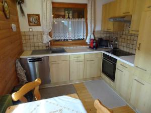 a small kitchen with a sink and a stove at Chalet in Diex near Klopeiner See with sauna in Diex