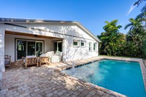 a swimming pool in front of a house at Pet-Friendly Retreat in Stuart with Saltwater Pool! in Stuart