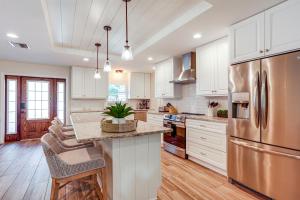 a kitchen with white cabinets and a stainless steel refrigerator at Pet-Friendly Retreat in Stuart with Saltwater Pool! in Stuart