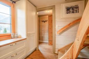 a tiny house with a staircase in a room at Reste Fidèle Duplex in Fiesch