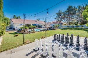 a chess board on a sidewalk in front of a yard at Luxury Vegas Home with 5BR, Casita, Hot Tub, and Pool in Las Vegas