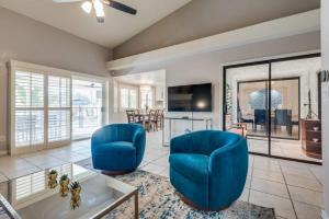 a living room with two blue chairs and a table at Luxury Vegas Home with 5BR, Casita, Hot Tub, and Pool in Las Vegas