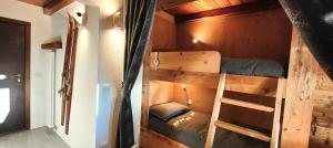 a bunk bed in a tiny house with a ladder at Hostdomus - Stoccolma Suite in Sestriere