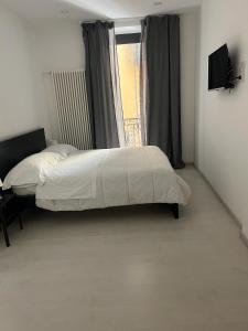a bedroom with a bed and a window with a television at Residenza Marcelli in Isernia