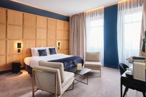 a hotel room with a bed and a chair at Maison Heym Bordeaux in Bordeaux +37 photos