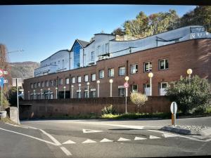 a large brick building on the side of a street at Comosole in Como