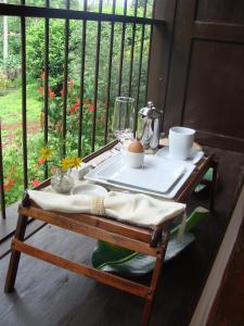 a table on a porch with a tray of food at Hotel Hacienda El Roble in Los Santos