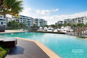a large swimming pool with buildings in the background at Allisee Apartments in Gold Coast