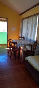 a dining room with a table and chairs in a room at Casa Verde do Paulo in Santana do Riacho